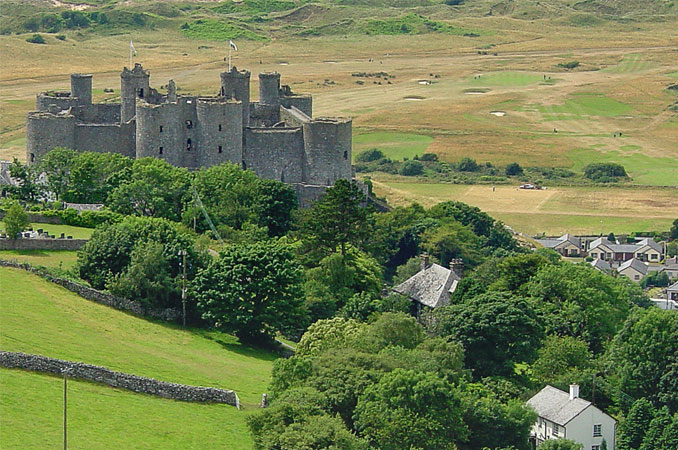 Picture of a castle in Wales surrounded by rolling green hills.